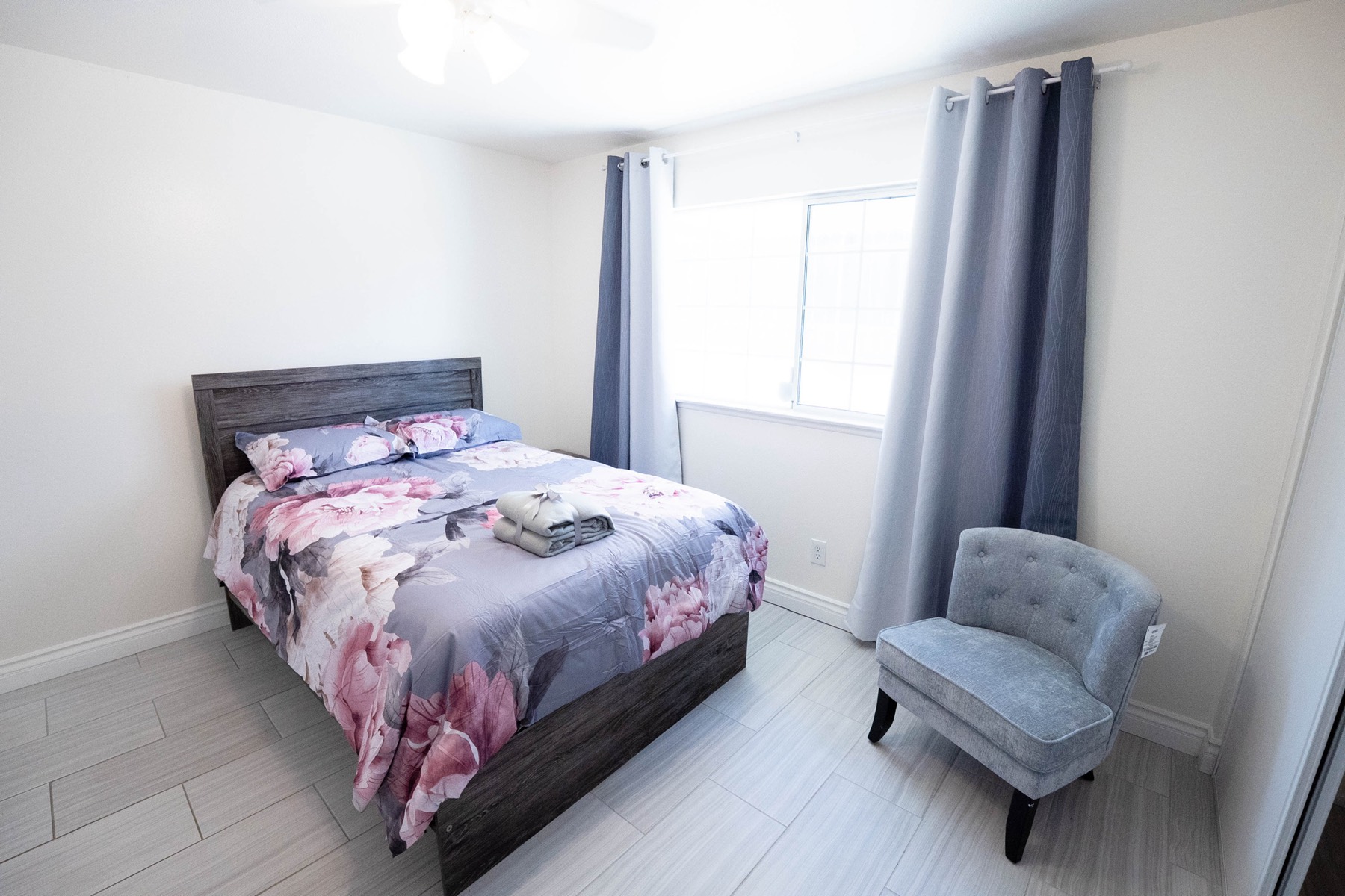 Cheerful private bedroom with floral accents and natural light