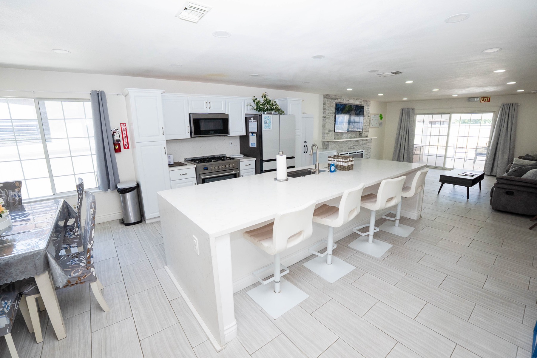 Spacious great room with plush seating, natural light from large windows, and warm accent decor