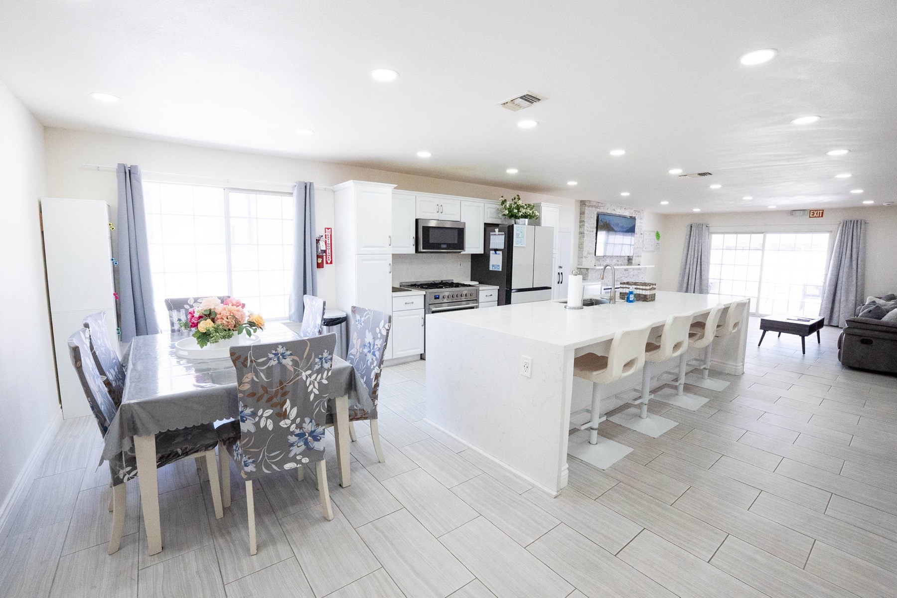 Bright open-plan living and dining area with fresh flowers